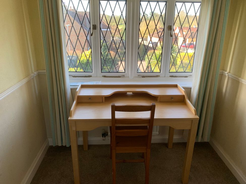 A desk and chair in front of a window at Highfields in Caunton near Southwell