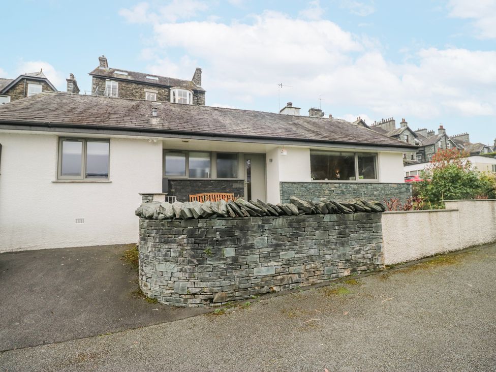 A house with a stone wall and garden at Ambwray in Ambleside
