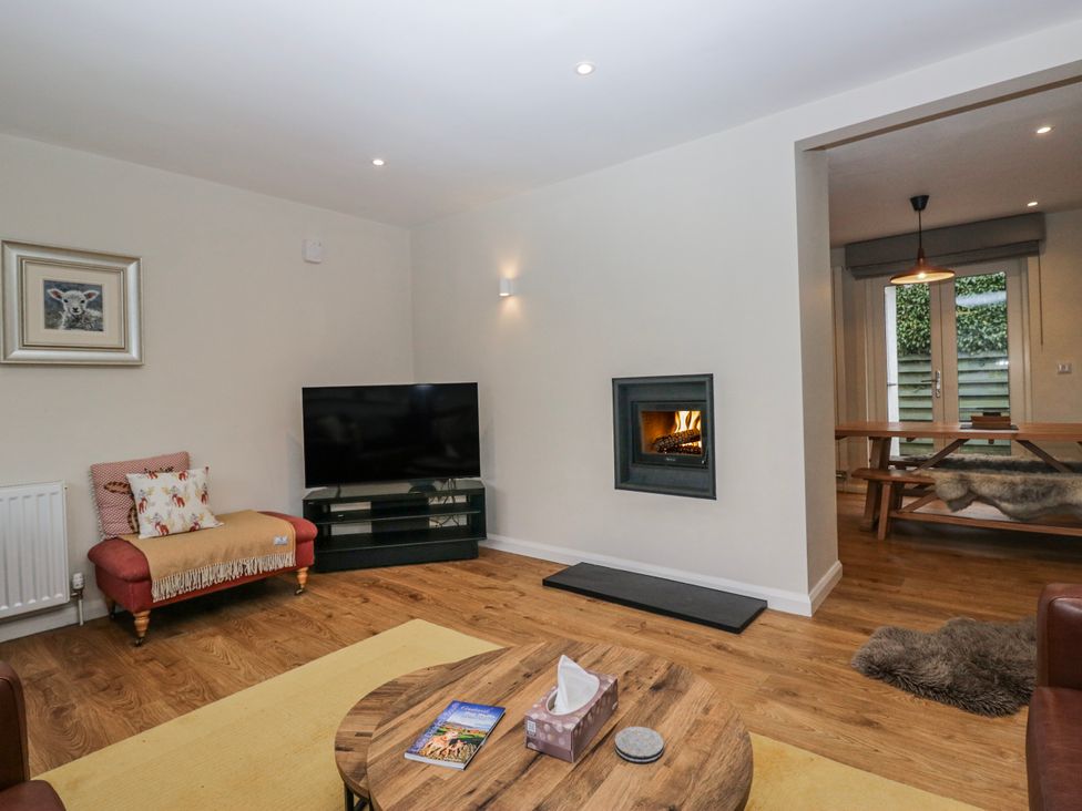 A living room with a television and fireplace at Ambwray in Ambleside