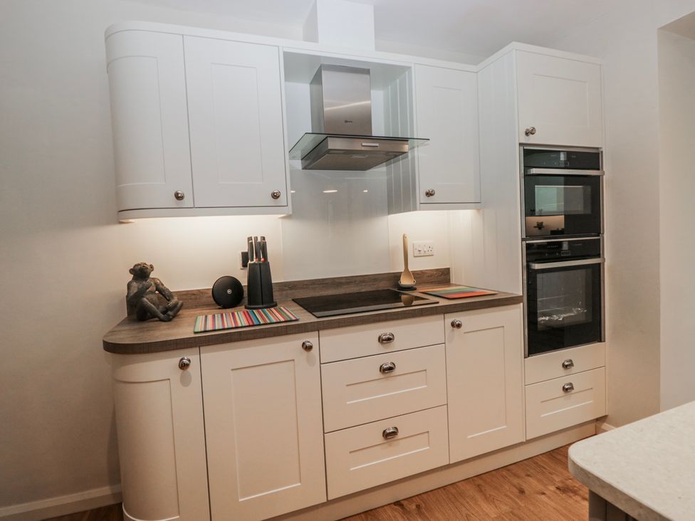A kitchen with cabinets, countertop and appliances at Ambwray in Ambleside