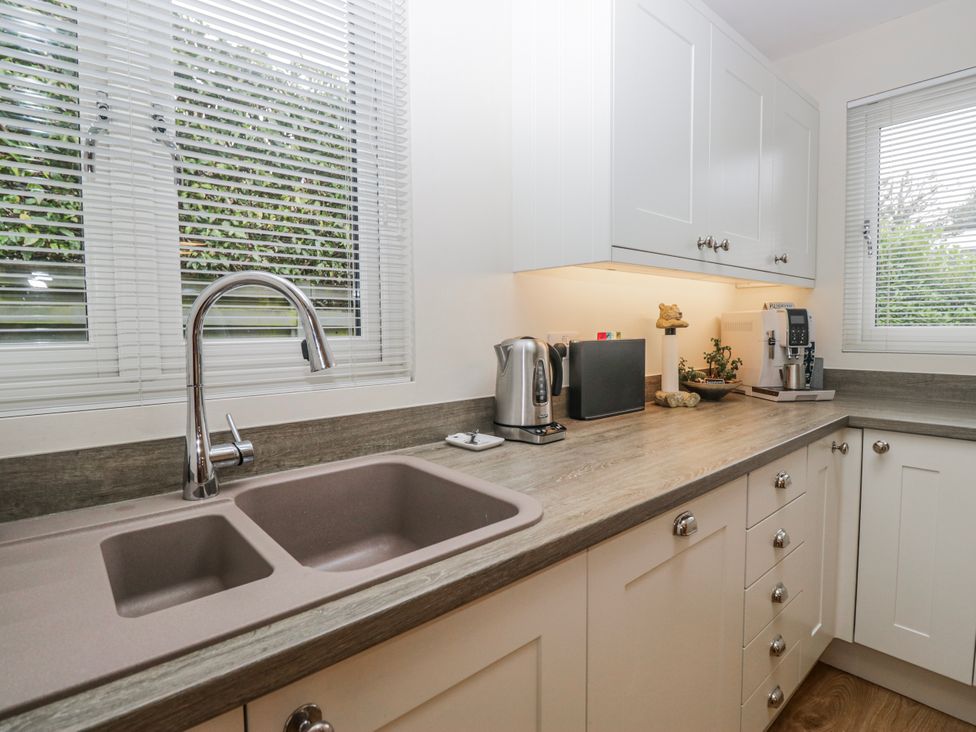 A kitchen with a sink and appliances at Ambwray in Ambleside