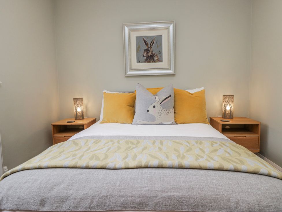 A bedroom with a bed and bedside tables at Ambwray in Ambleside