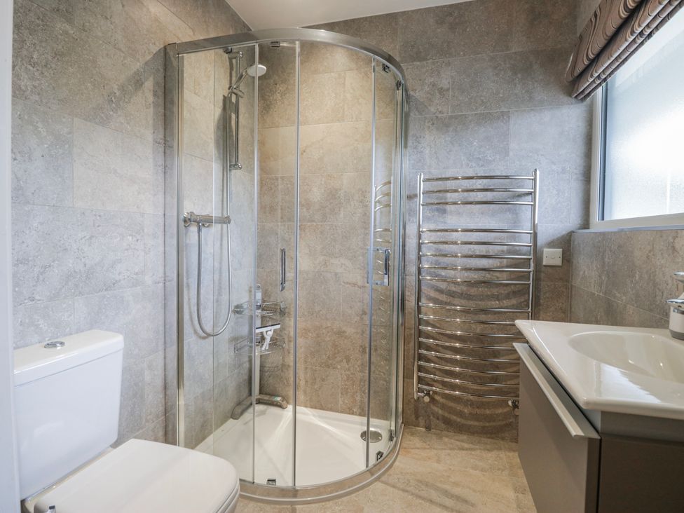 A bathroom with a shower, toilet, and sink at Ambwray in Ambleside