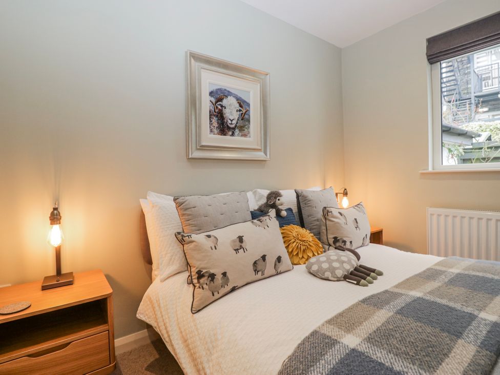A bedroom with a bed and decorative pillows at Ambwray in Ambleside