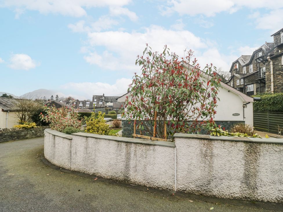 A property with trees and a wall at Ambwray in Ambleside