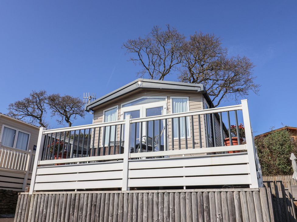 A holiday home with a deck and trees at Bordeaux in Ladram Bay Otterton