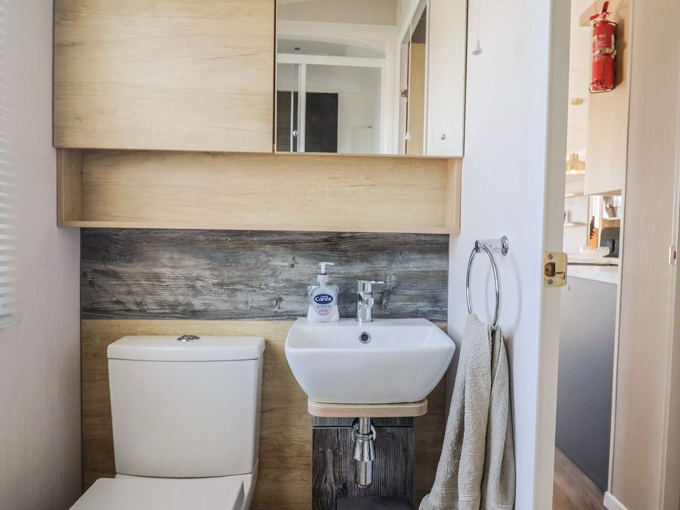 A bathroom with a toilet and sink at Bordeaux, Ladram Bay Otterton