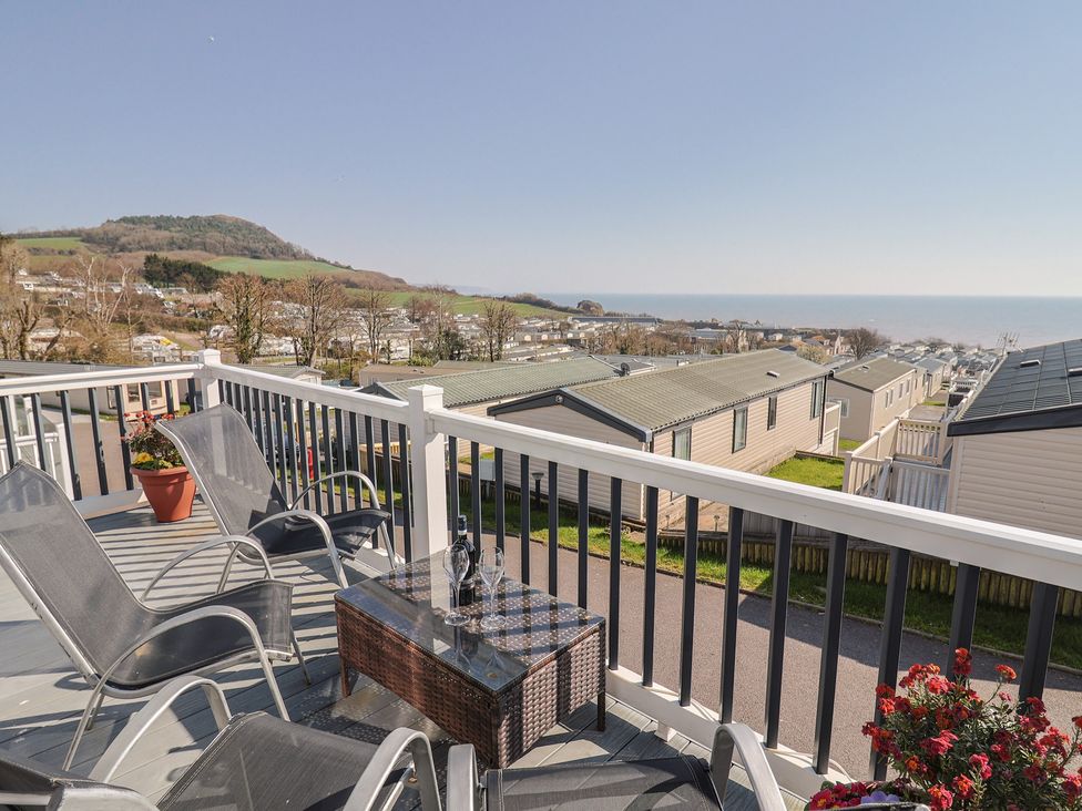 A balcony view overlooking the sea and hills at Bordeaux in Ladram Bay Otterton