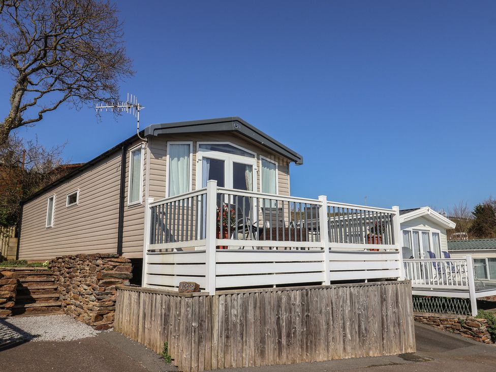 A mobile home with a deck and steps at Bordeaux in Ladram Bay Otterton