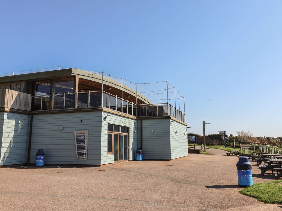 An outdoor area with a building and seating at Bordeaux Ladram Bay Otterton