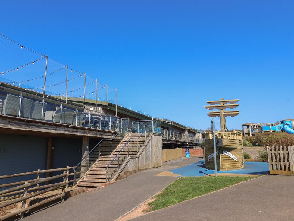 An outdoor area with a play structure and stairs at Bordeaux in Ladram Bay Otterton