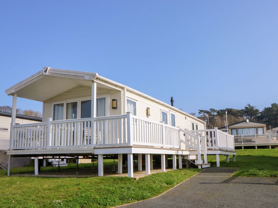 A mobile home with a deck and steps at 63 Crosswinds in Bembridge