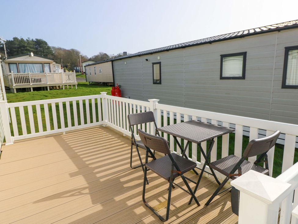 A deck with a table and chairs at 63 Crosswinds in Bembridge