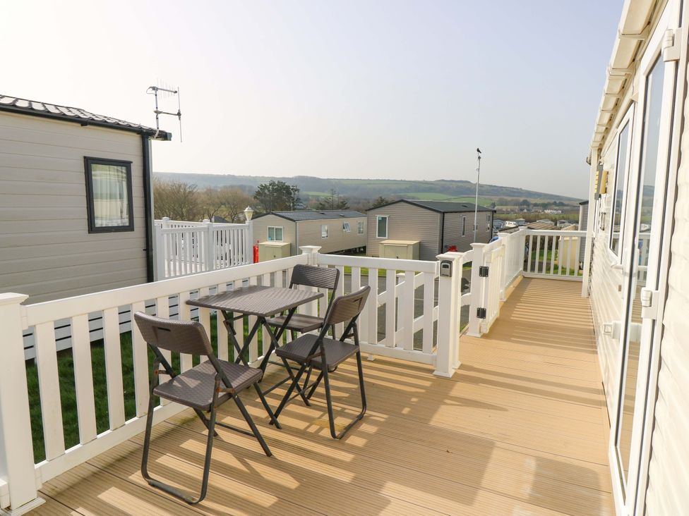 A deck with table and chairs at 63 Crosswinds in Bembridge
