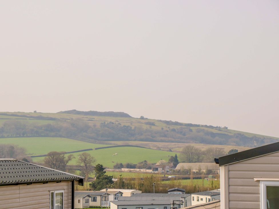 A view of hills and mobile homes at 63 Crosswinds in Bembridge