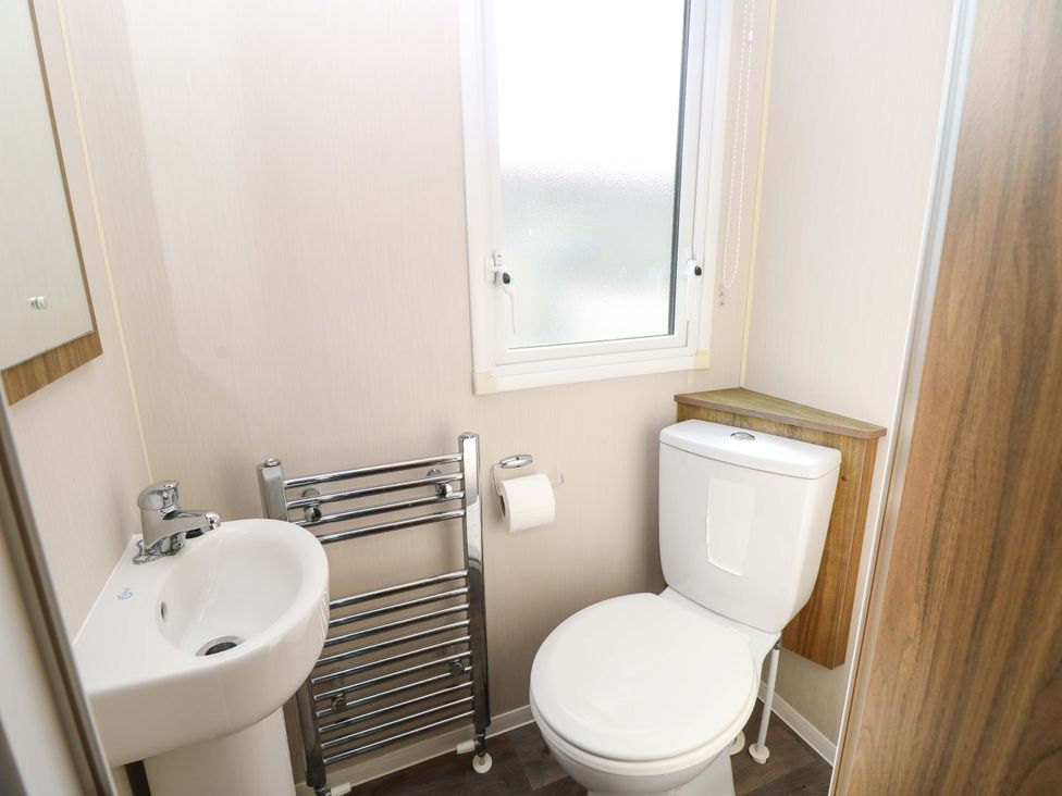 A bathroom with a sink and toilet at 63 Crosswinds near Bembridge