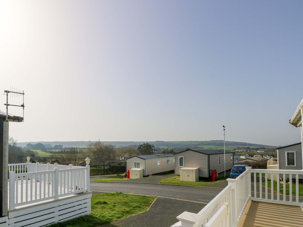 A view of caravans and hills from a deck at 63 Crosswinds Hillway near Bembridge