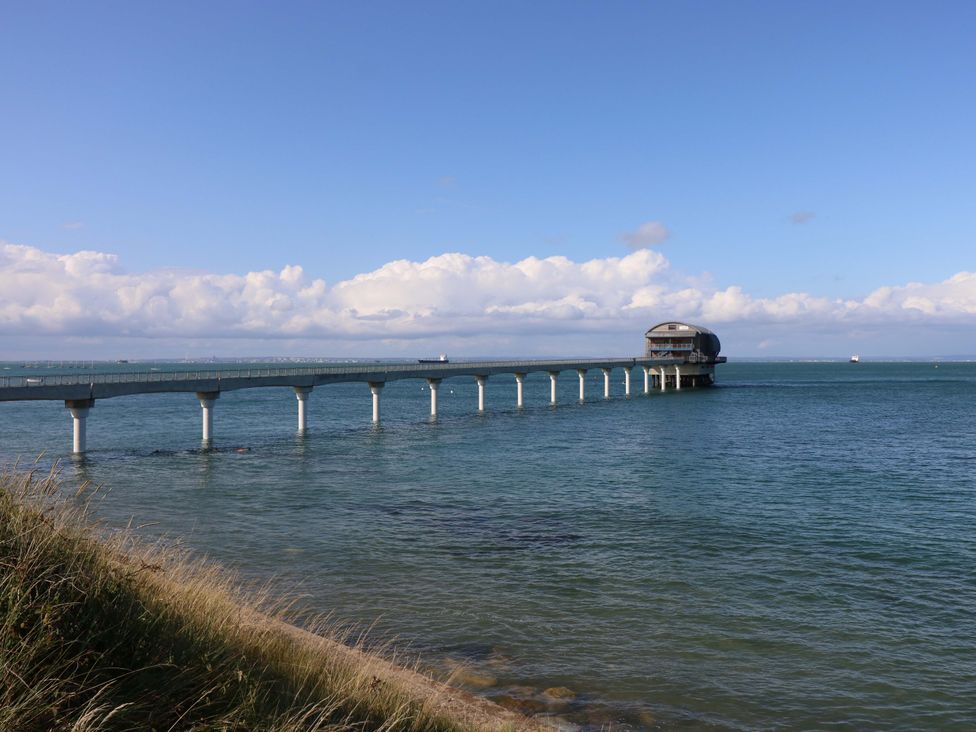 A pier extending over the water with a building at the end near Hillway near Bembridge