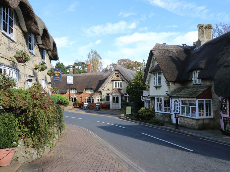 A street with thatched roof buildings and a pub at 63 Crosswinds Hillway near Bembridge