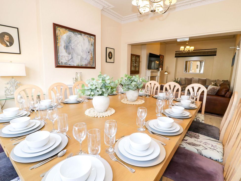 A dining room with a table set for dinner at The Causeway in Llandudno