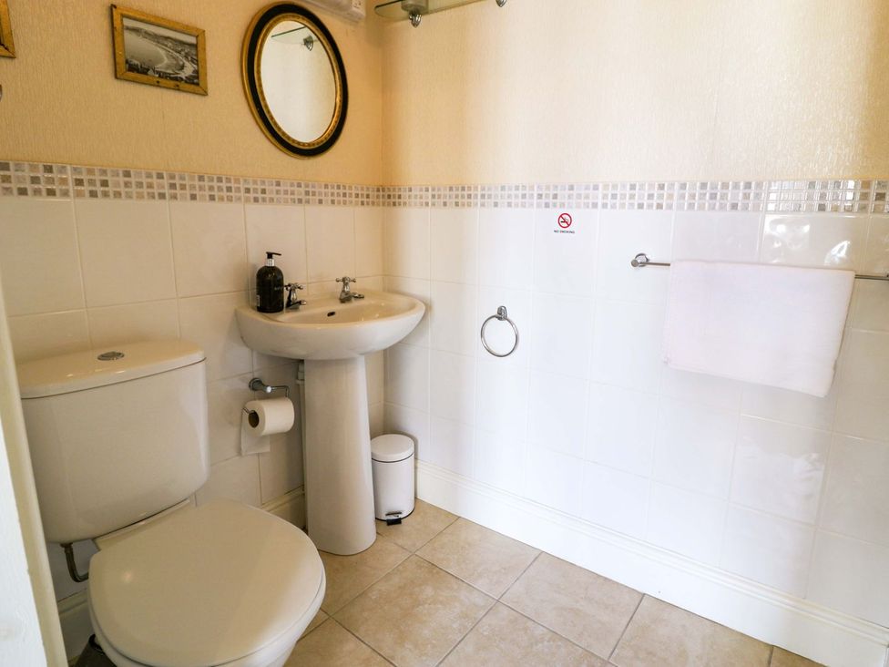 A bathroom with a toilet and sink at The Causeway in Llandudno