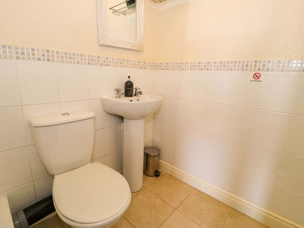 A bathroom with a sink and toilet at The Causeway in Llandudno