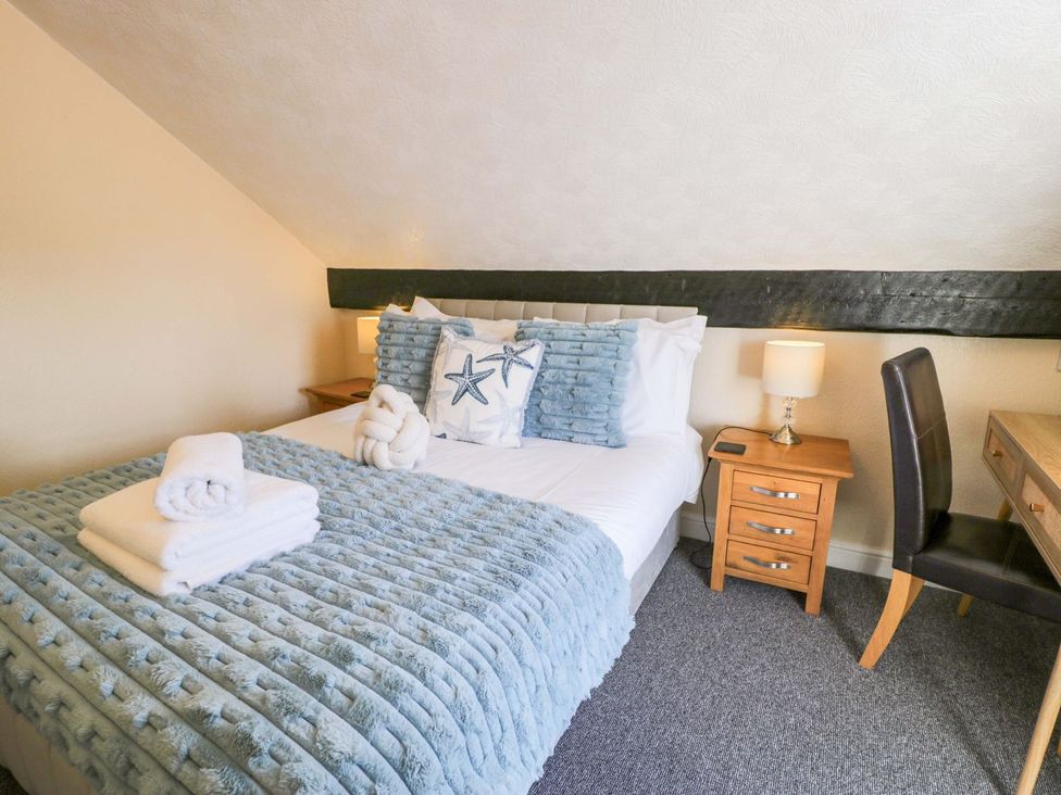 A bedroom with a bed and bedside table at The Causeway Llandudno