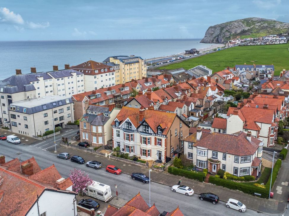 An aerial view of residential buildings and coastline at The Causeway in Llandudno