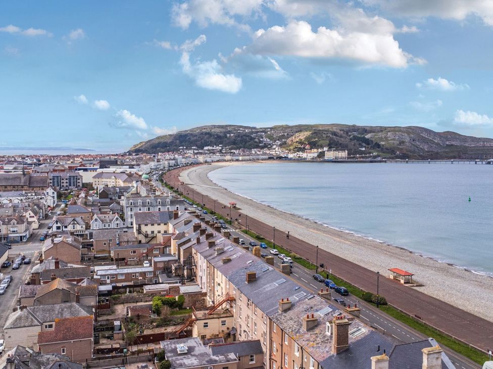 An outdoor view of buildings and a beach at The Causeway in Llandudno