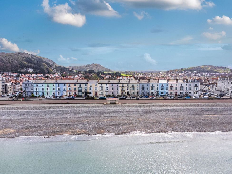 A row of buildings along the beach at The Causeway in Llandudno