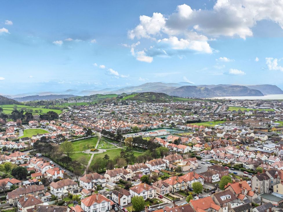 An aerial view of residential area with houses and green spaces at The Causeway Llandudno