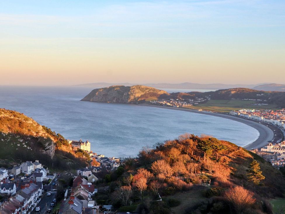 A coastal view with a town and hills at The Causeway in Llandudno
