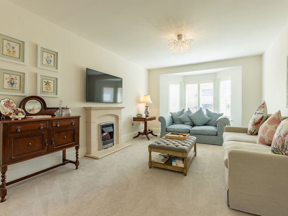A living room with a television and sofa at Old Railway Close in Lechlade-On-Thames