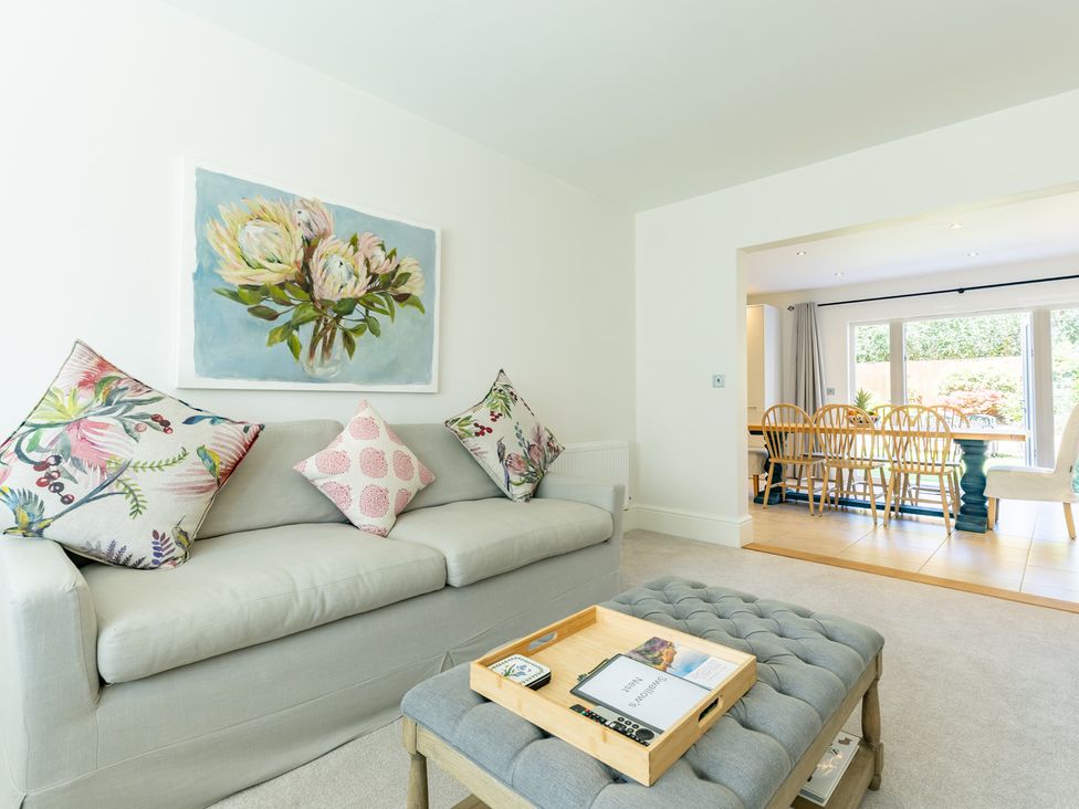 A living room with a sofa and a dining area at Old Railway Close Lechlade-On-Thames