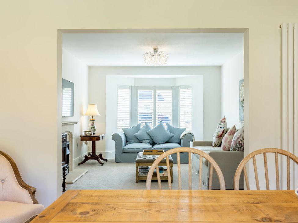 A dining room with a view into a living room at Old Railway Close in Lechlade-On-Thames