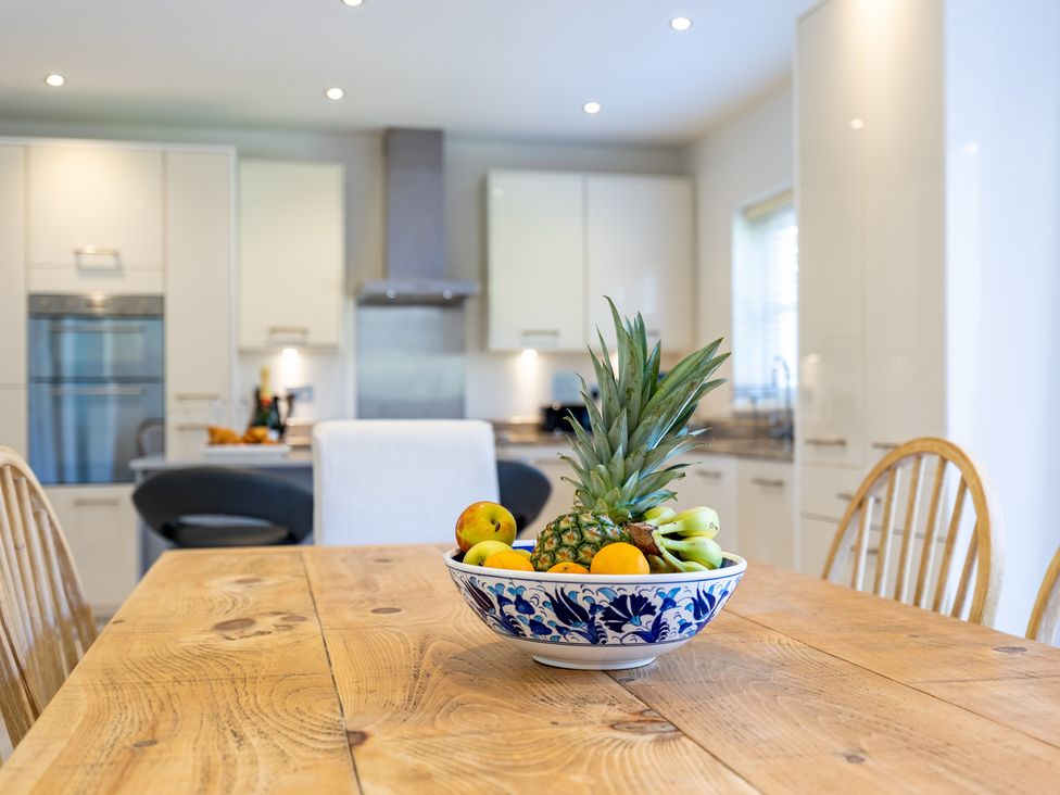 A kitchen with a fruit bowl on a wooden table at Old Railway Close in Lechlade-On-Thames