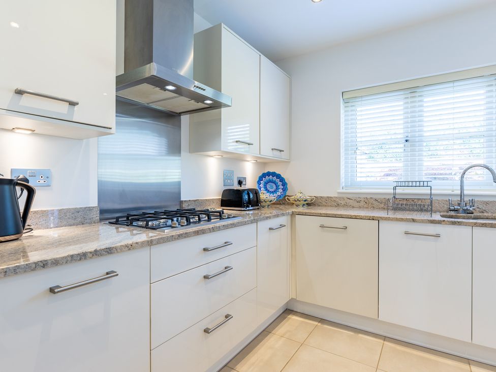 A kitchen with a stove and kettle at Old Railway Close in Lechlade-On-Thames