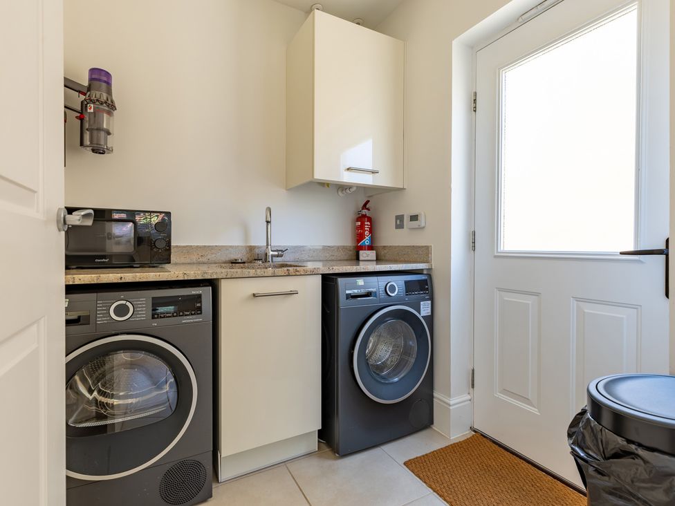 A laundry room with a washing machine and dryer at Old Railway Close in Lechlade-On-Thames