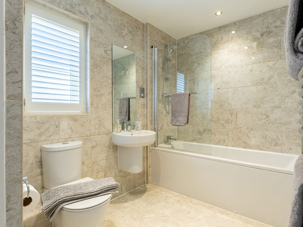 A bathroom with a shower and sink at Old Railway Close in Lechlade-On-Thames