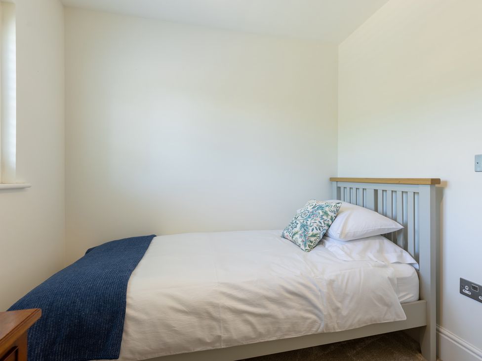 A bedroom with a bed and a window at Old Railway Close in Lechlade-On-Thames