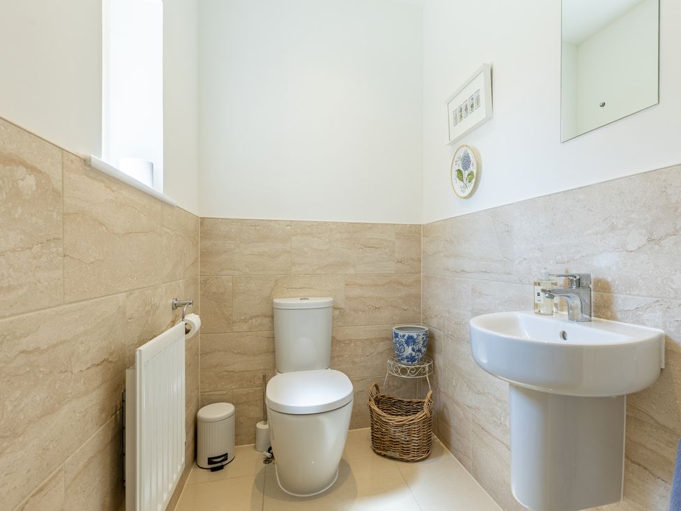 A bathroom with a toilet and sink at Old Railway Close in Lechlade-On-Thames
