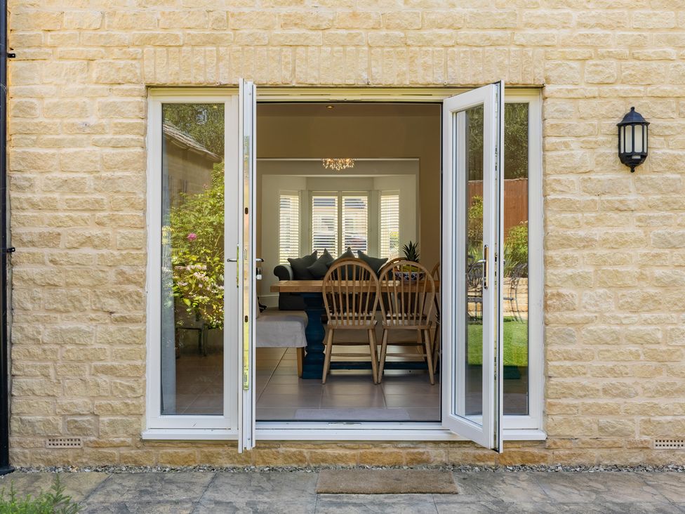 A dining room view with glass doors at Old Railway Close Lechlade-On-Thames