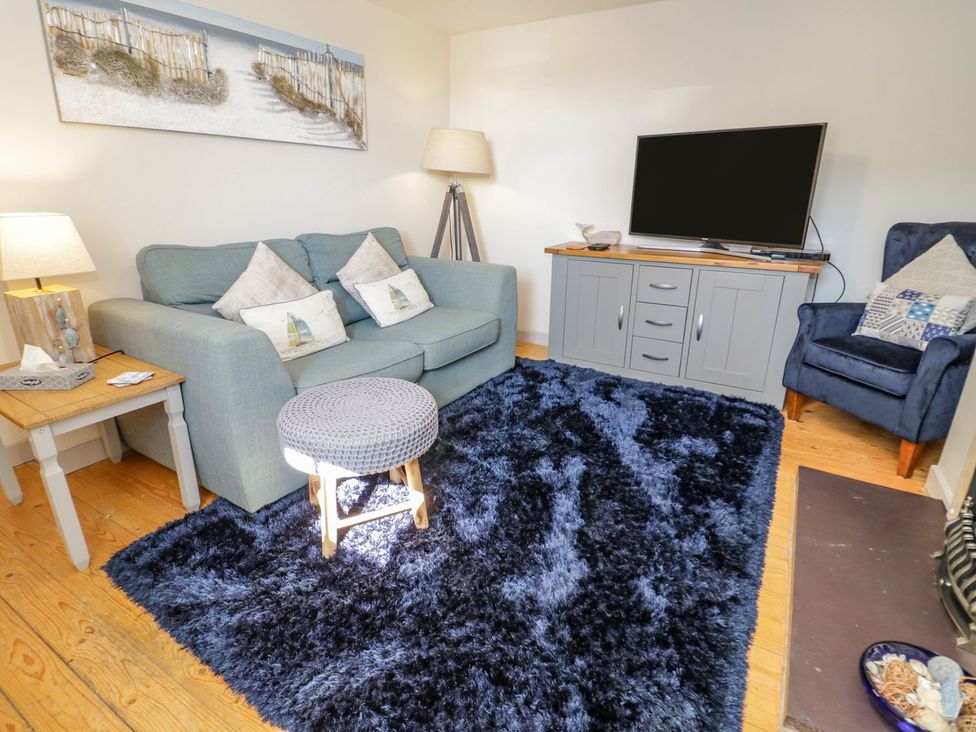 A living room with a sofa and television at Eryri View Retreat