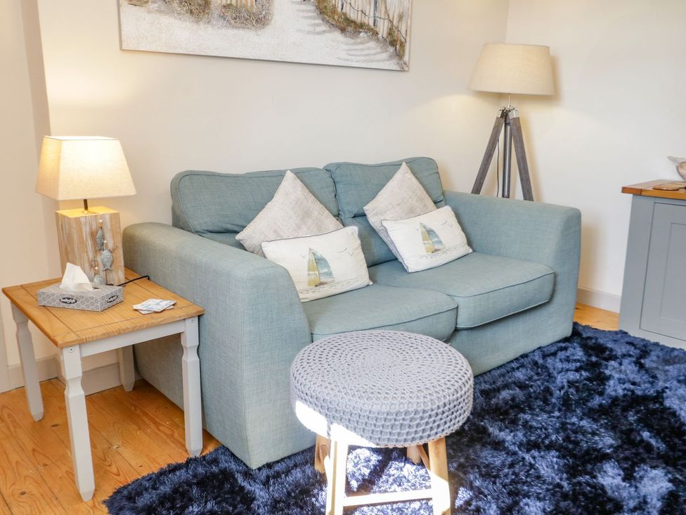 A living room with a sofa and side table at Eryri View Retreat 