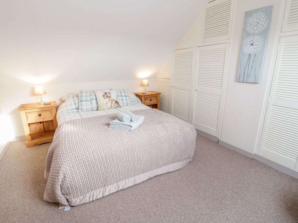 A bedroom with a bed and nightstands at Eryri View Retreat
