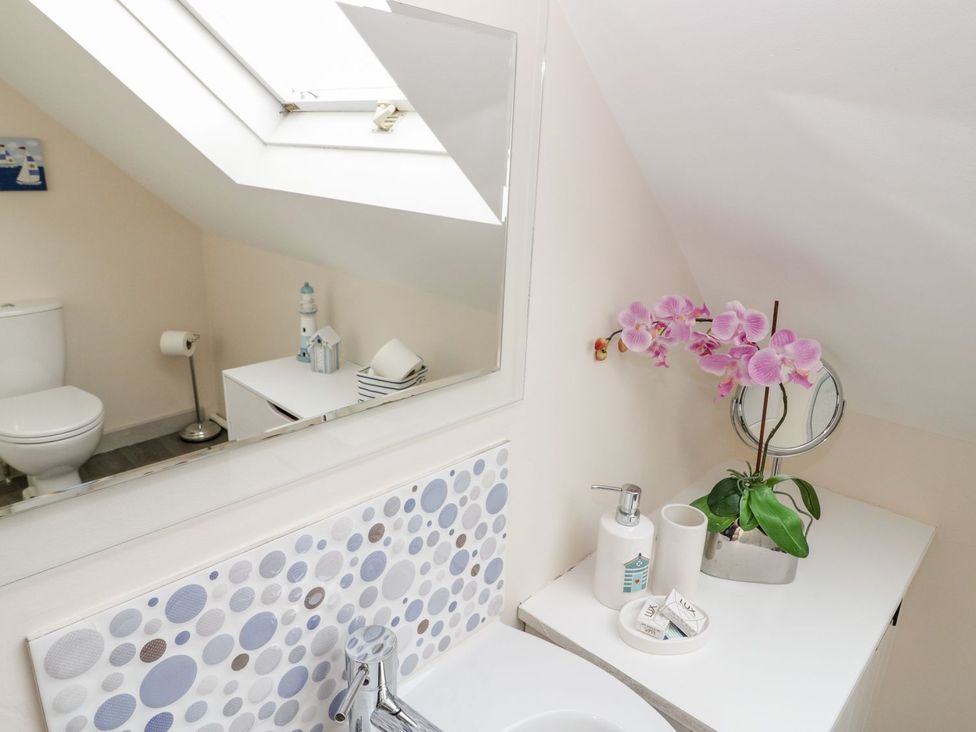 A bathroom with a toilet and sink at Eryri View Retreat