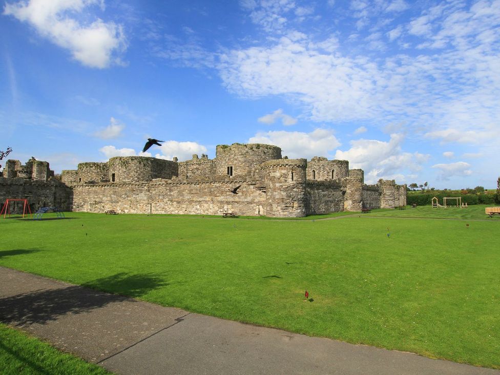 A castle with green grass and playground equipment at Eryri View Retreat 