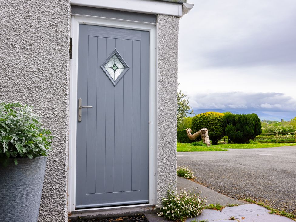 A gray door with a diamond window at Eryri View Retreat Llangoed near Beaumaris