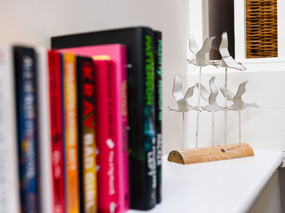 A display of books and a decorative sculpture at Eryri View Retreat in Llangoed near Beaumaris