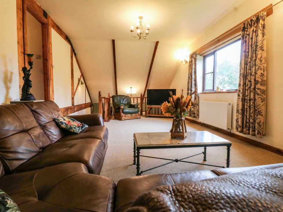A living room with a sofa and coffee table at The Barn in Tamworth